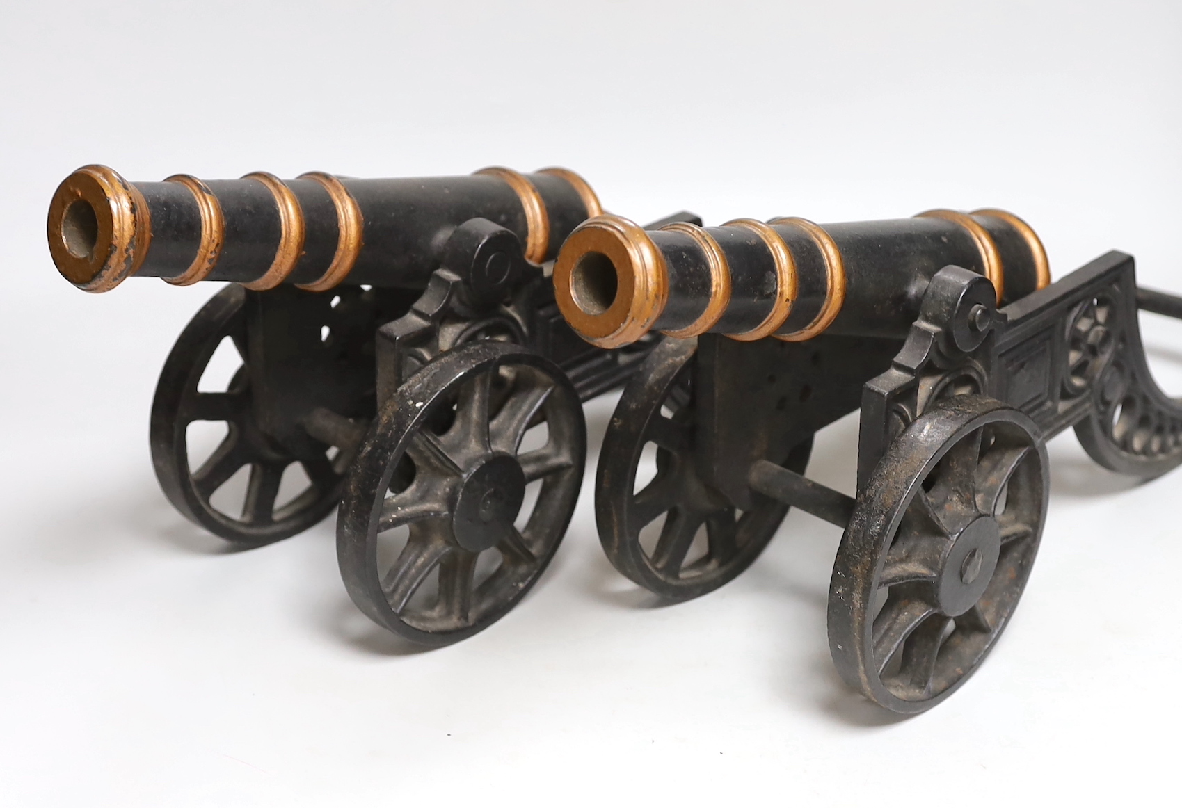 A pair of cast iron models of cannons, 48cm long